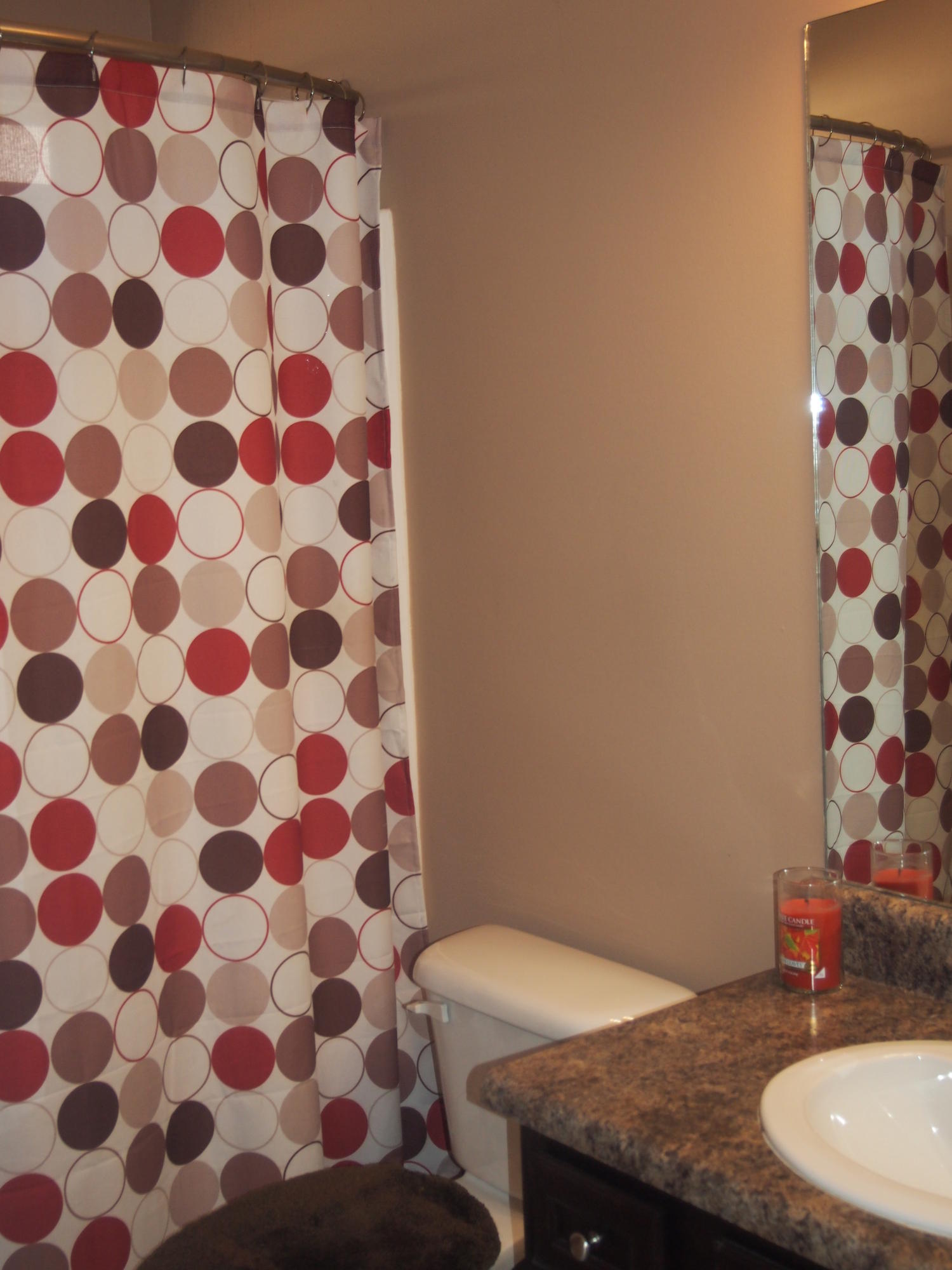 9273 Sundance Court Navarre, FL 32566 - Photo 23 of 33 a bathroom with a granite countertop sink and a mirror