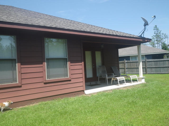 9273 Sundance Court Navarre, FL 32566 - Photo 29 of 33 a front view of a house with a yard