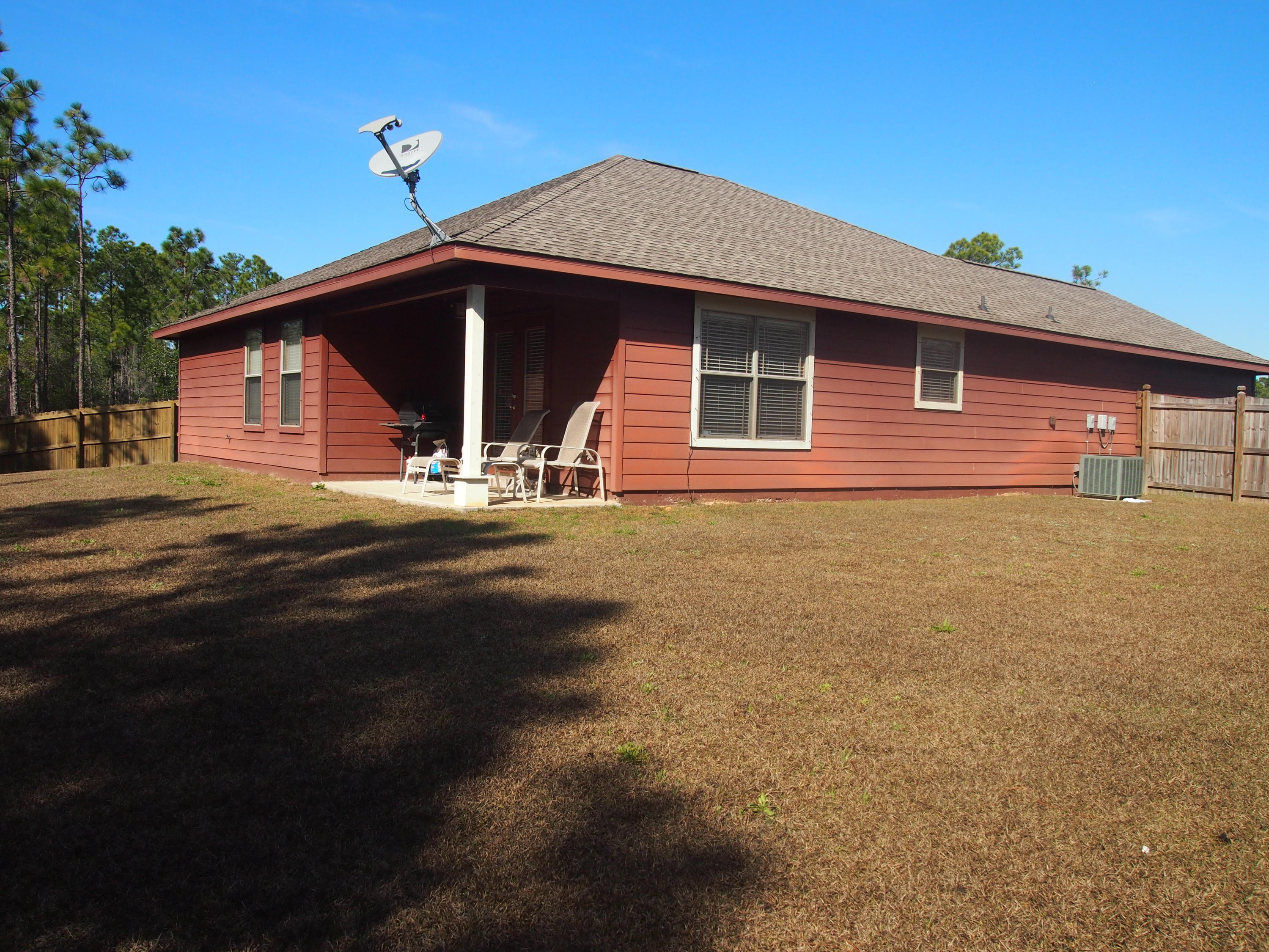 9273 Sundance Court Navarre, FL 32566 - Photo 31 of 33 a front view of a house with a yard