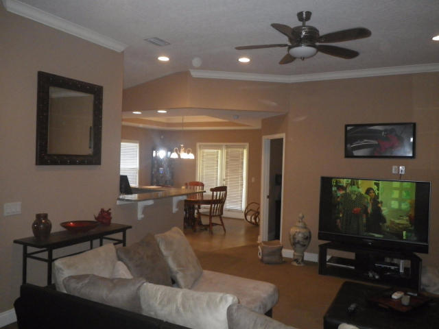 9273 Sundance Court Navarre, FL 32566 - Photo 6 of 33 a living room with furniture and a flat screen tv