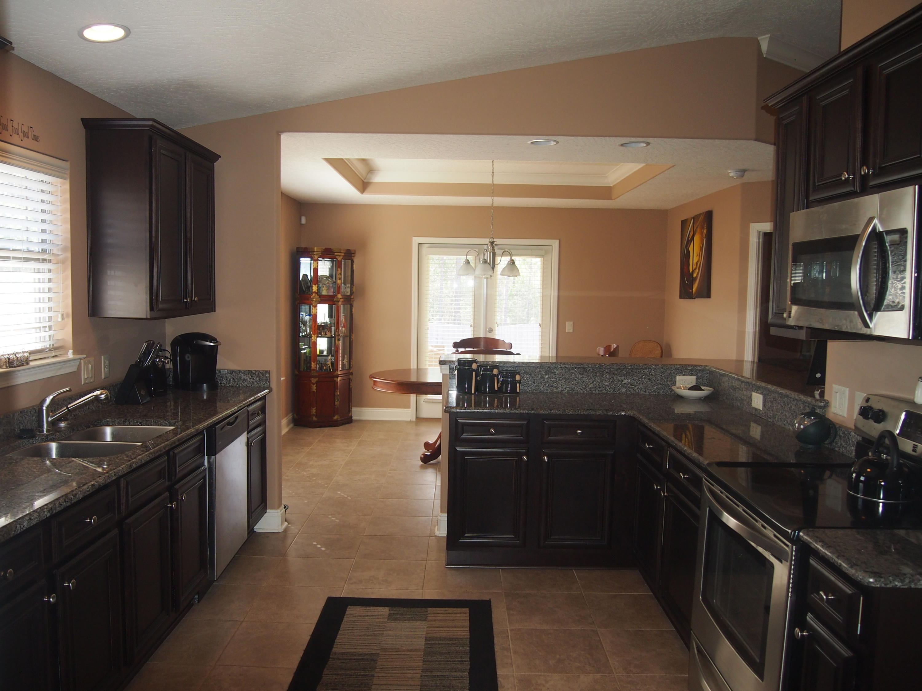 9273 Sundance Court Navarre, FL 32566 - Photo 7 of 33 a kitchen with a sink stove and refrigerator