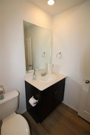 a bathroom with a sink mirror vanity and toilet