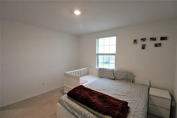 a bedroom with a bed and window