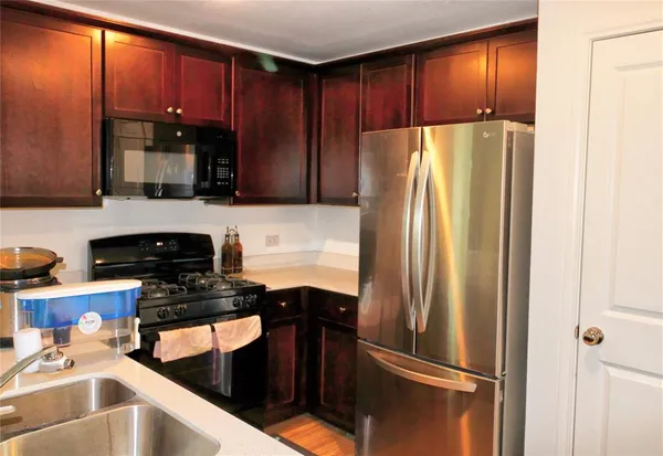 a kitchen with a refrigerator and a sink
