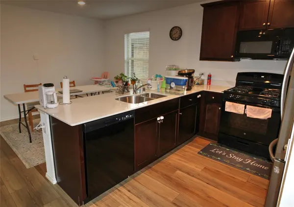 a kitchen with a sink and a stove top oven