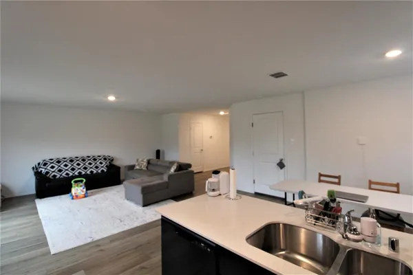 a kitchen that has a sink and a table in it