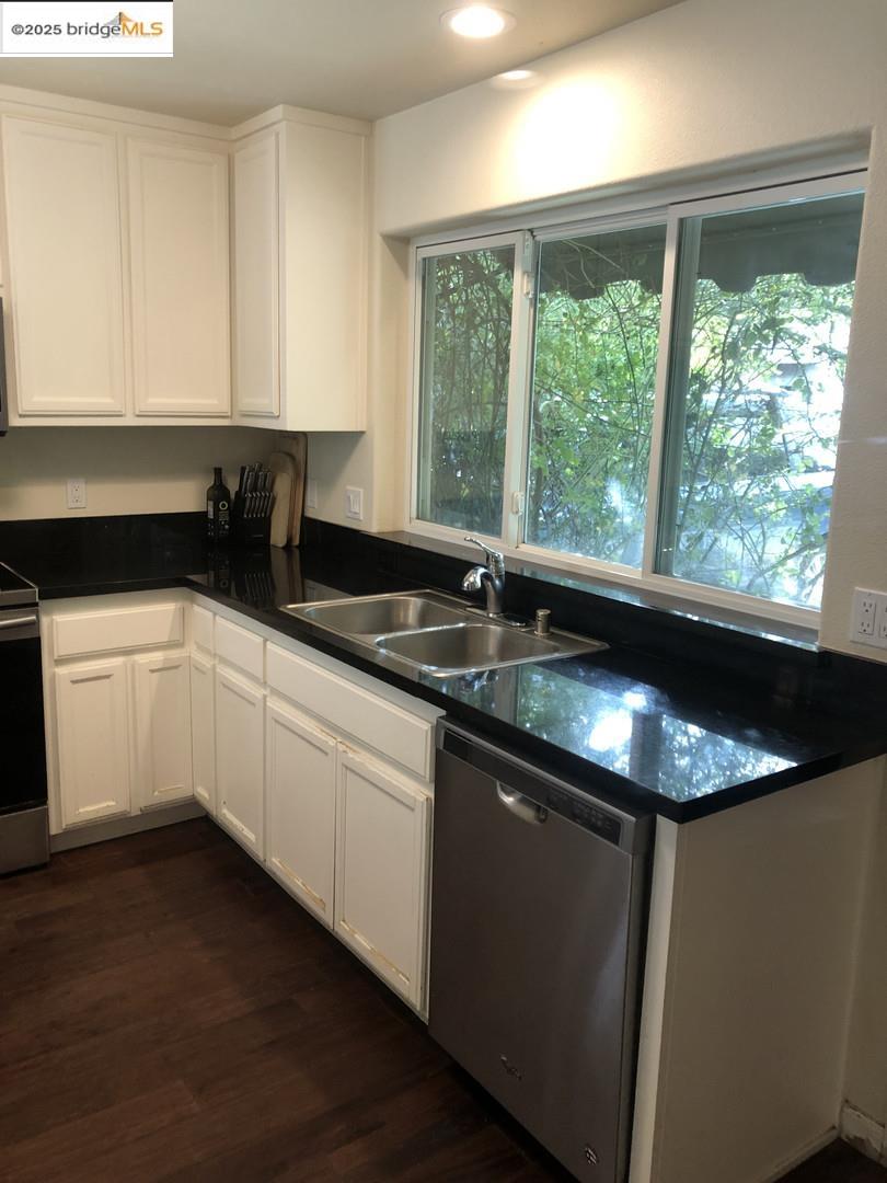 4088 Hackberry Place Davis, CA 95618 - Photo 23 of 58 a kitchen with granite countertop a sink and white cabinets