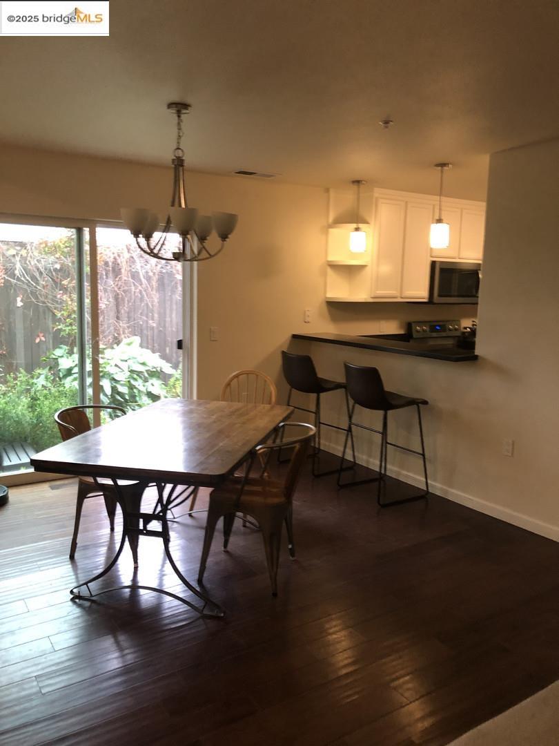 4088 Hackberry Place Davis, CA 95618 - Photo 27 of 58 a view of a dining room with furniture window and wooden floor