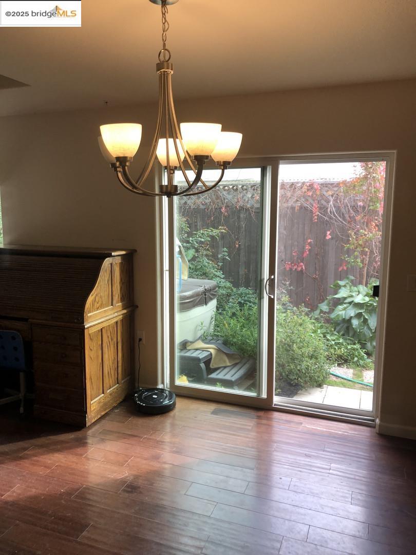 4088 Hackberry Place Davis, CA 95618 - Photo 29 of 58 a very nice looking room with wooden floor a chandelier