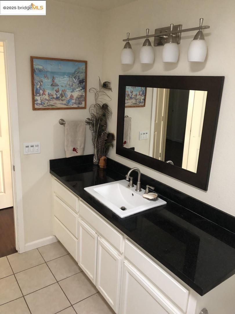 4088 Hackberry Place Davis, CA 95618 - Photo 45 of 58 a bathroom with a sink and a mirror
