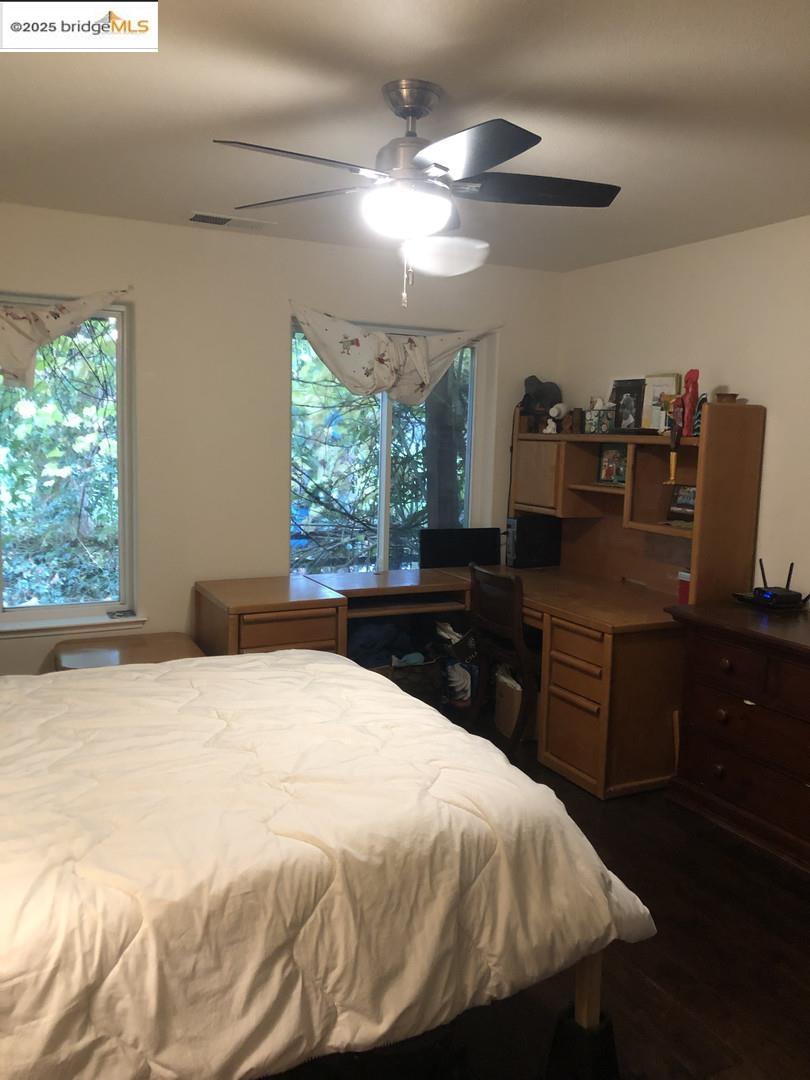 4088 Hackberry Place Davis, CA 95618 - Photo 50 of 58 a bedroom with a large bed and dresser with mirror