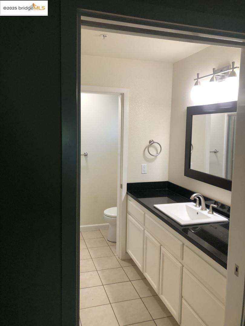 4088 Hackberry Place Davis, CA 95618 - Photo 52 of 58 a bathroom with a granite countertop sink and a mirror