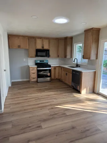 a kitchen with stainless steel appliances granite countertop a stove and a sink
