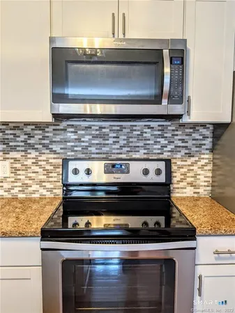 a stove top oven sitting inside of a kitchen