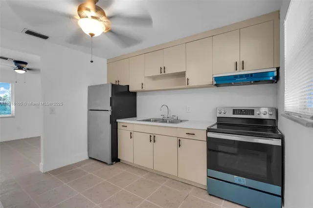 a kitchen with cabinets stainless steel appliances and a counter space