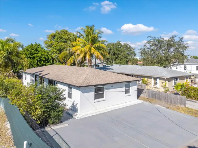 an aerial view of a house with a yard and potted plants