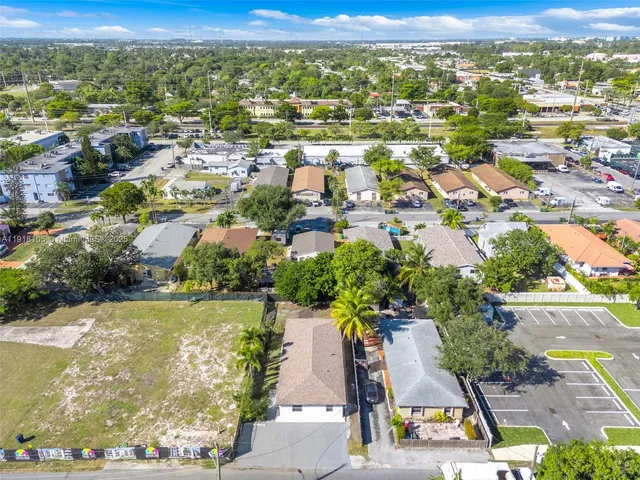 an aerial view of residential houses with outdoor space and river