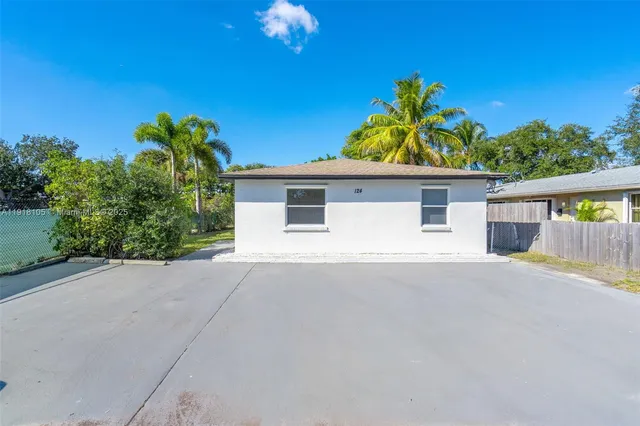 a house with a yard and a wooden fence