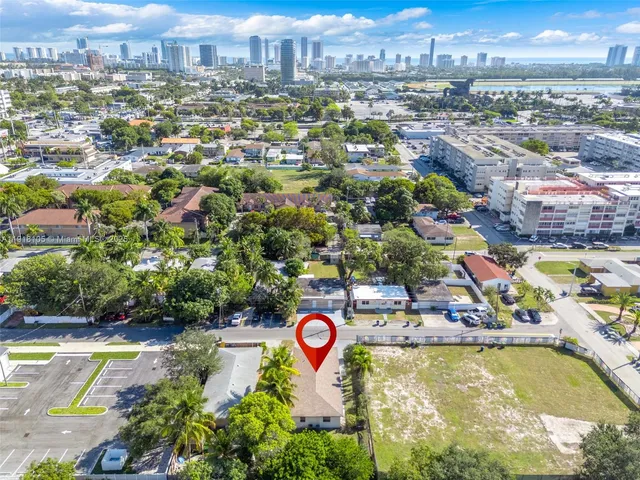 an aerial view of residential houses with yard