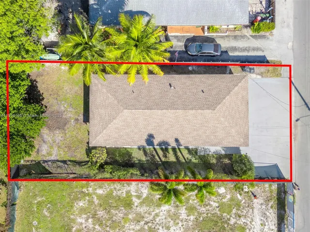 a view of swimming pool with a yard and plants