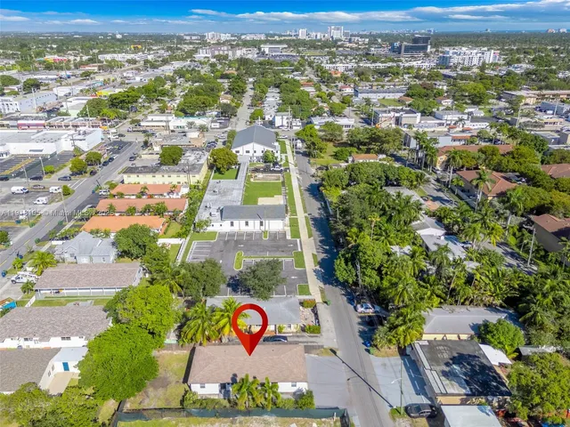 an aerial view of residential houses with outdoor space and street view