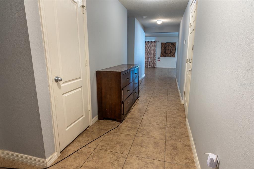 4563 Orchard Grove Road St. Cloud, FL 34772 - Photo 15 of 51 a view of a hallway with wooden shelves