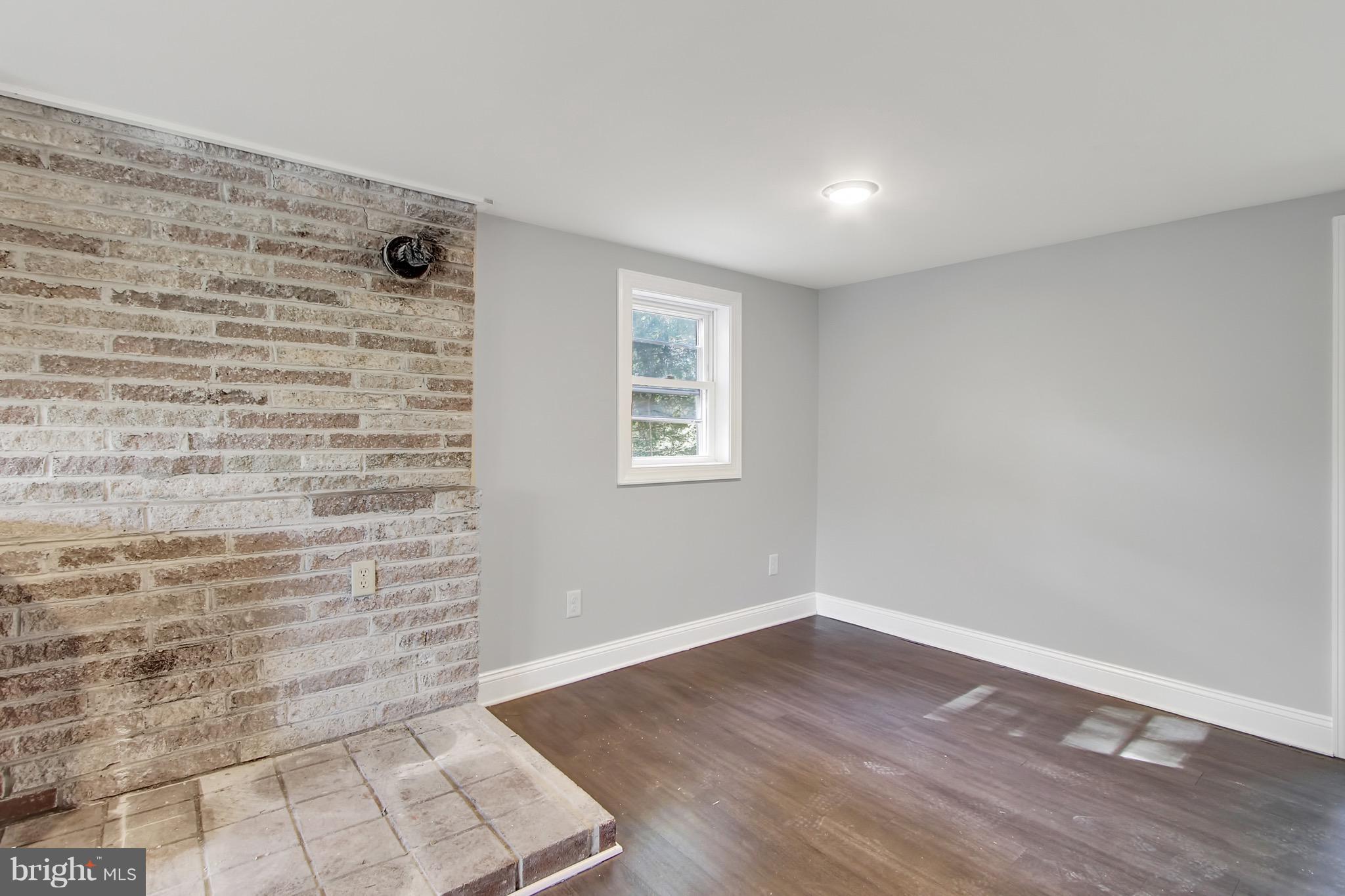 1807 Jug Road Dover, PA 17315 - Photo 8 of 27 a view of an empty room with wooden floor and a window