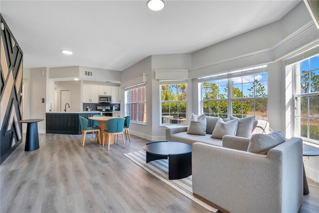 8601 Worldquest Boulevard, Unit 3108 Orlando, FL 32821 - Photo 11 of 24 a living room with furniture and a large window