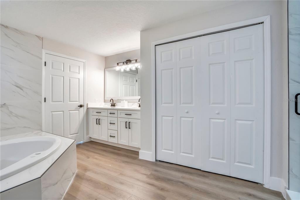 8601 Worldquest Boulevard, Unit 3108 Orlando, FL 32821 - Photo 13 of 24 a bathroom with a sink a bathtub and a shower