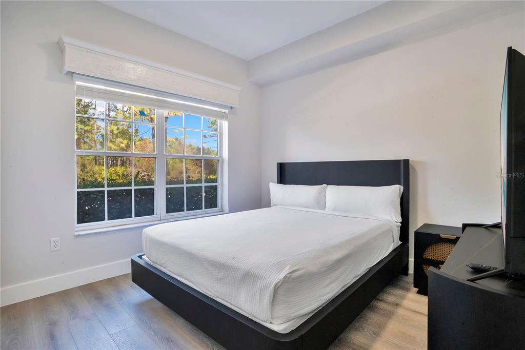 8601 Worldquest Boulevard, Unit 3108 Orlando, FL 32821 - Photo 15 of 24 a large bed sitting in a bedroom next to a window