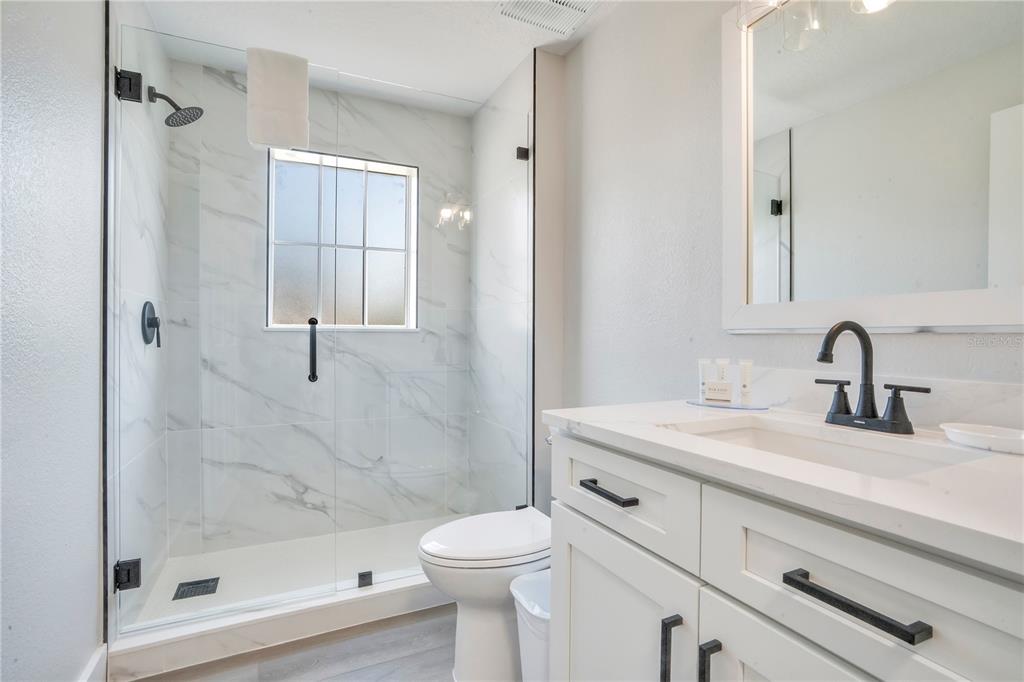 8601 Worldquest Boulevard, Unit 3108 Orlando, FL 32821 - Photo 17 of 24 a bathroom with a sink a toilet and shower