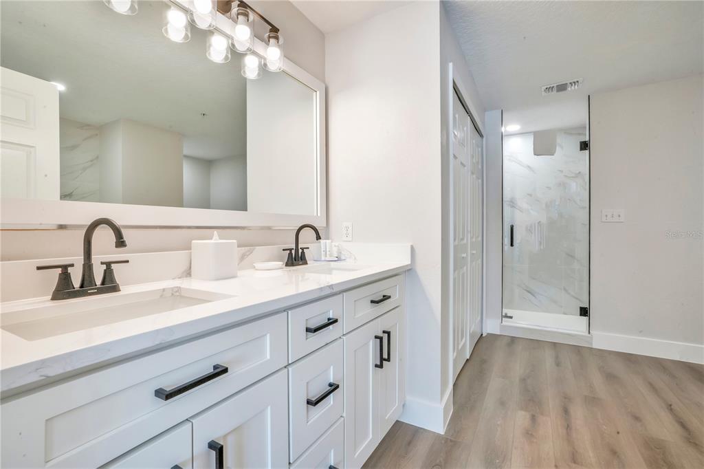 8601 Worldquest Boulevard, Unit 3108 Orlando, FL 32821 - Photo 18 of 24 a spacious bathroom with a double vanity sink mirror and shower
