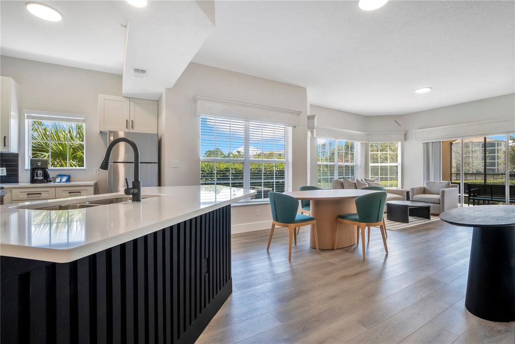 8601 Worldquest Boulevard, Unit 3108 Orlando, FL 32821 - Photo 2 of 24 a kitchen with counter top space and wooden floor