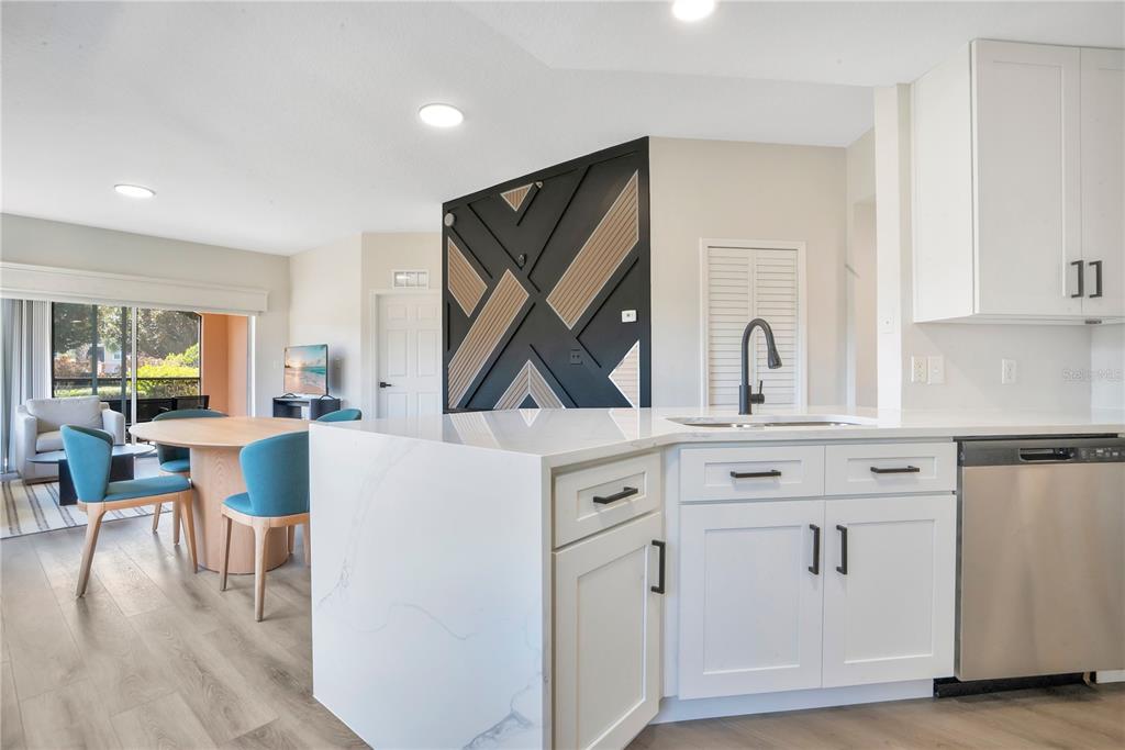 8601 Worldquest Boulevard, Unit 3108 Orlando, FL 32821 - Photo 7 of 24 a living room with white cabinets and wooden floor