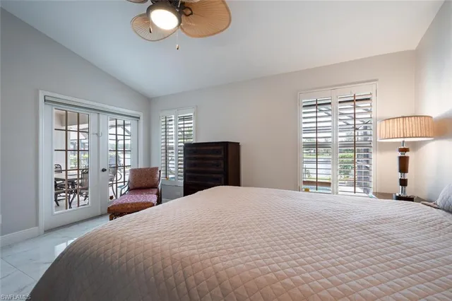 a bedroom with a large bed and a large window