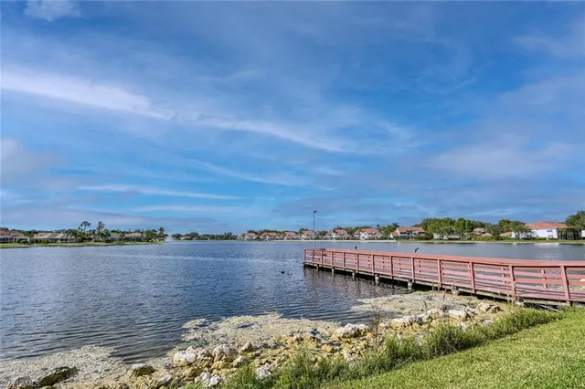 a view of a lake with houses in the back