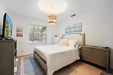 a bedroom with a bed and a tv on the dresser