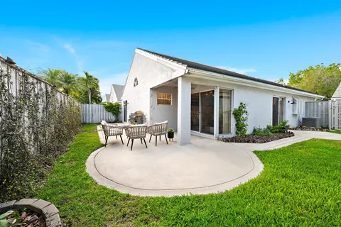 a view of a house with backyard sitting area and garden