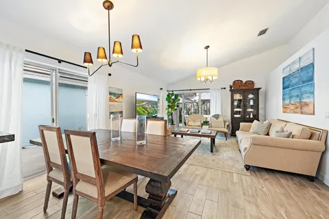 a living room with furniture a rug and a chandelier