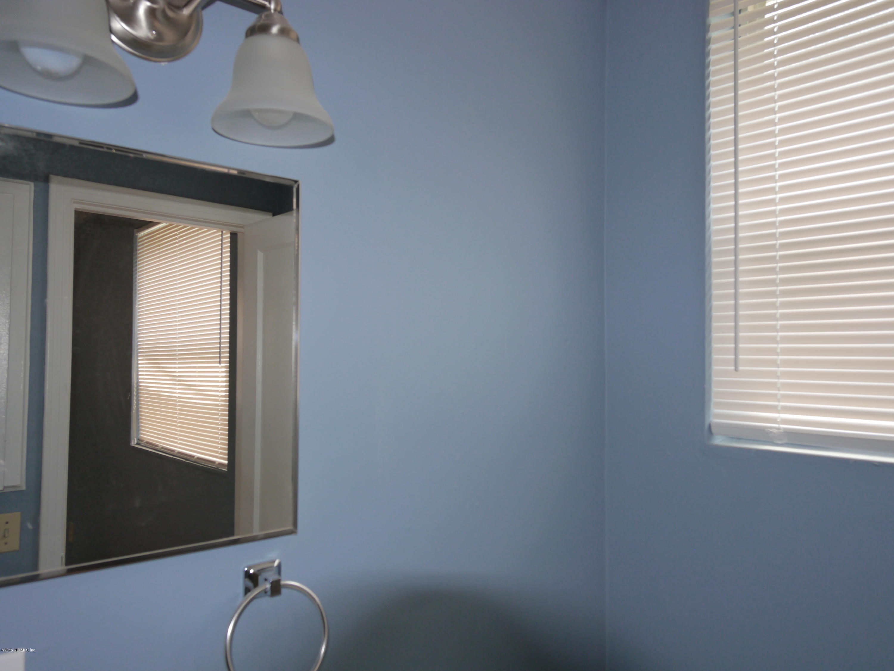 2153 Post Street, Unit 4 Jacksonville, FL 32204 - Photo 15 of 17 a bathroom with a toilet sink and mirror
