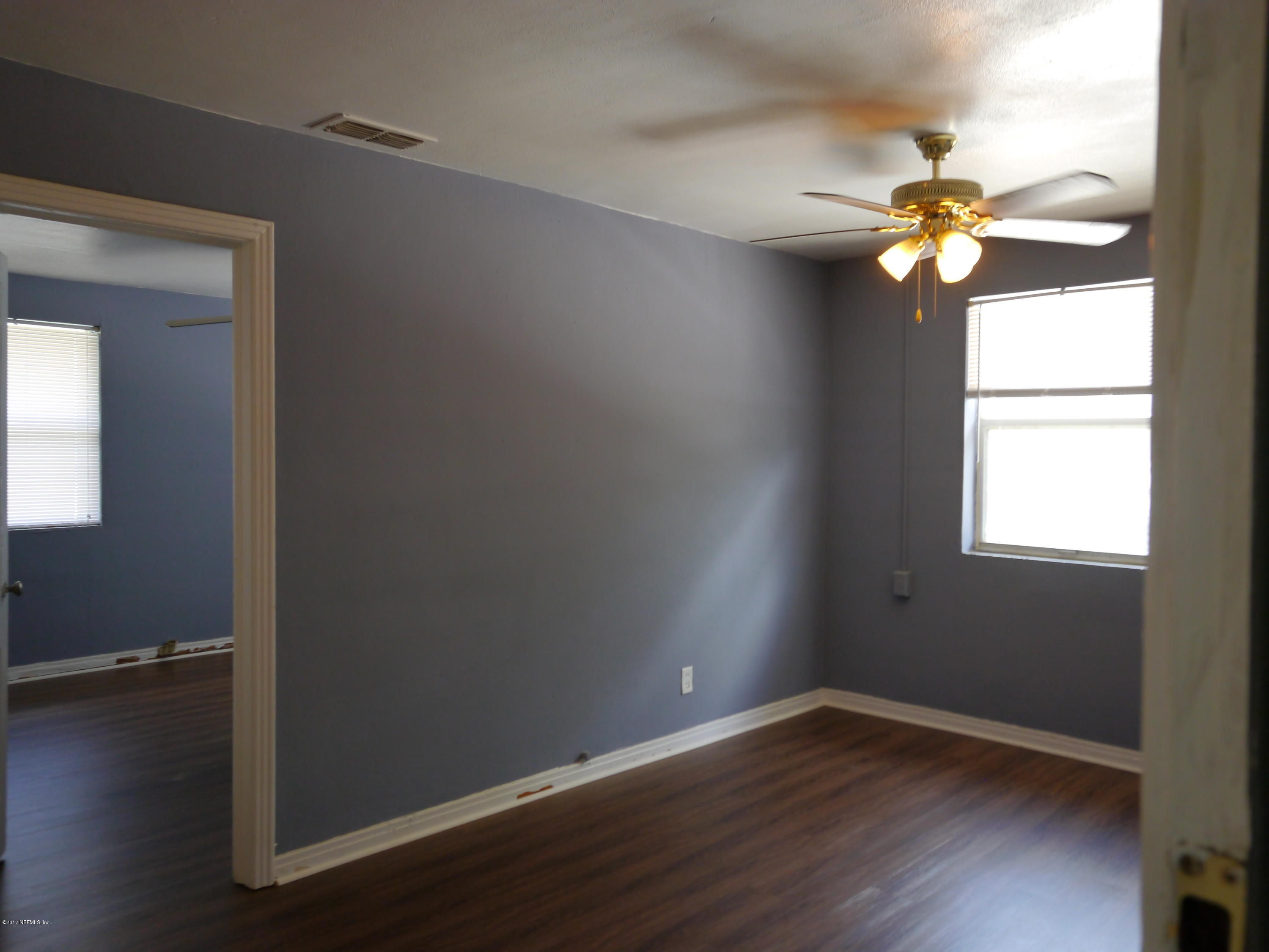 2153 Post Street, Unit 4 Jacksonville, FL 32204 - Photo 3 of 17 a view of an empty room with wooden floor and a window