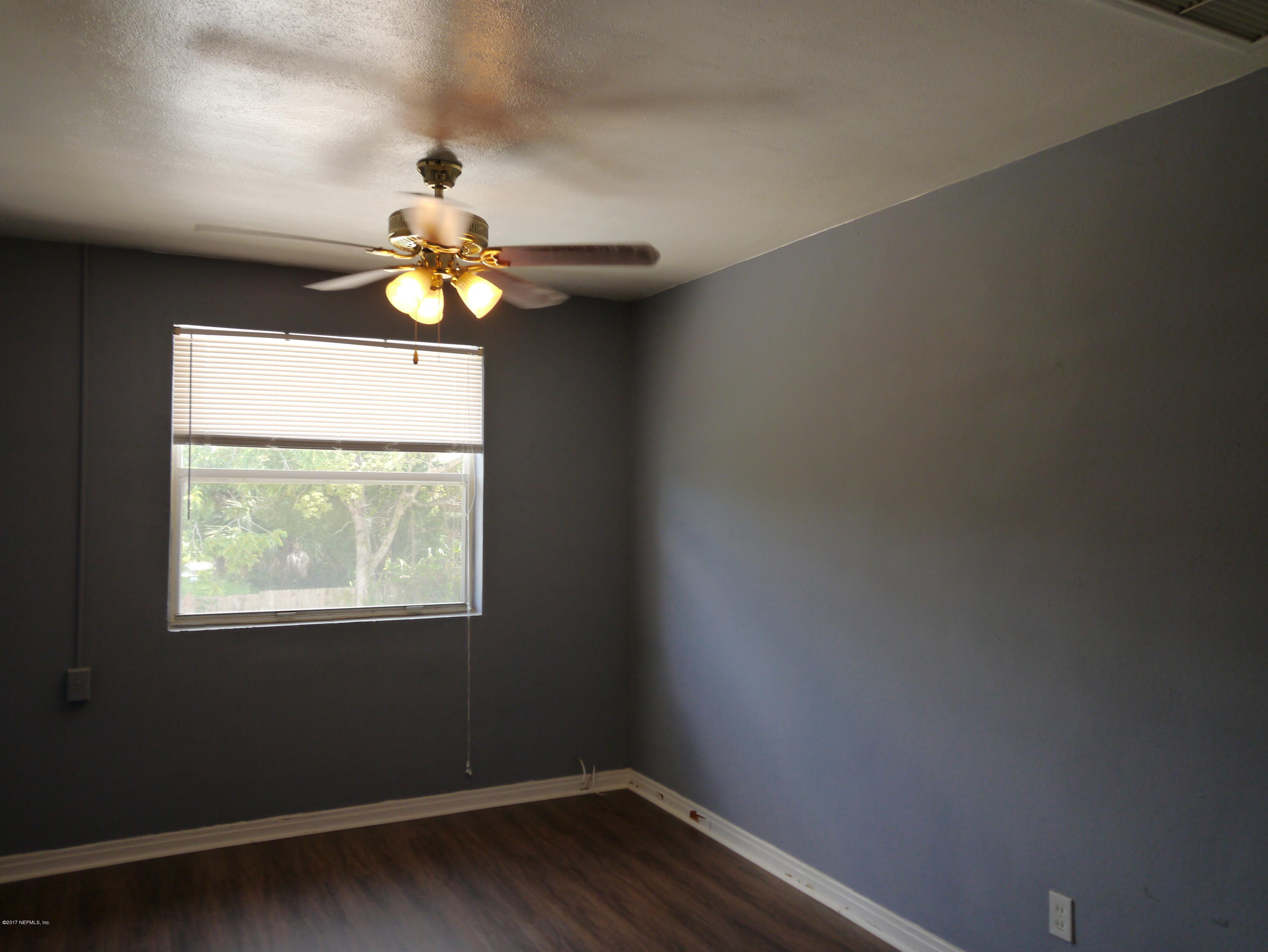 2153 Post Street, Unit 4 Jacksonville, FL 32204 - Photo 5 of 17 a a chandelier fan and window in the room