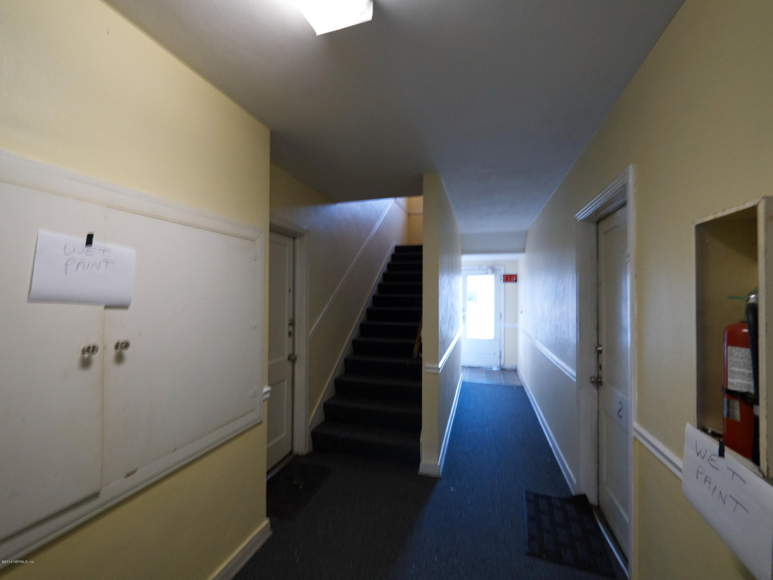 2153 Post Street, Unit 4 Jacksonville, FL 32204 - Photo 6 of 17 a view of a hallway with wooden floor and stairs