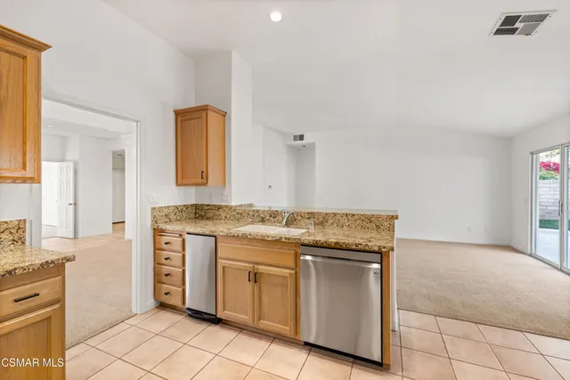 a kitchen with granite countertop a stove and a sink