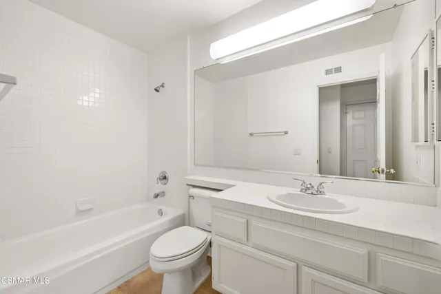 a view of small space with white cabinets