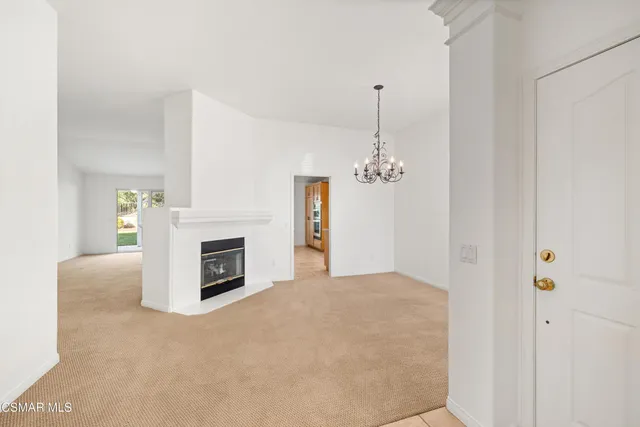 a view of a livingroom with a fireplace cabinet and window