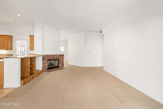 a view of a kitchen with furniture and a fireplace