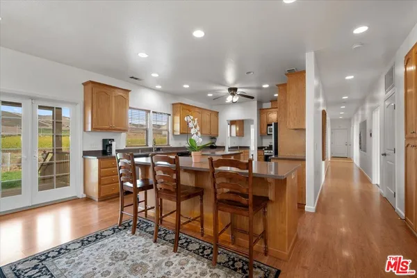 a kitchen with granite countertop cabinets stainless steel appliances and a counter space