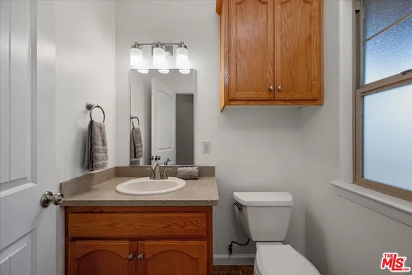 a view of a bedroom with a bed and a window