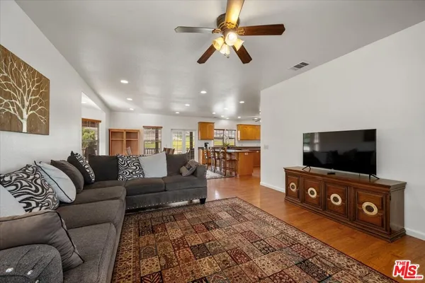 a kitchen with stainless steel appliances granite countertop a sink a stove and refrigerator